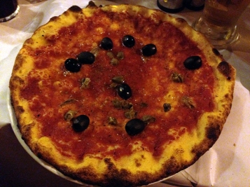 Pizza with tomato sauce, anchovies, and black olives